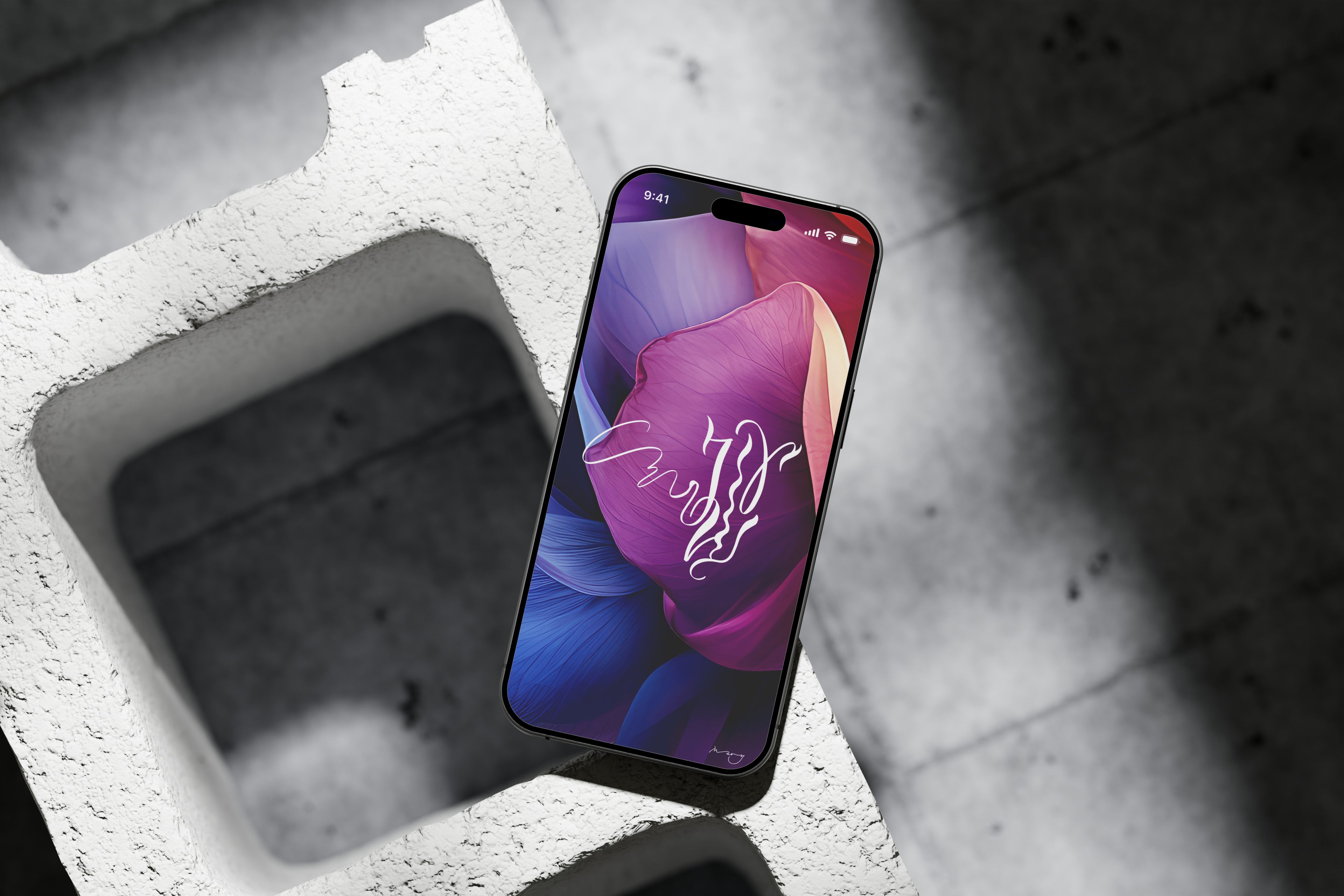 Black smartphone with the wallpaper on a lock screen with a calligraphy month July on it