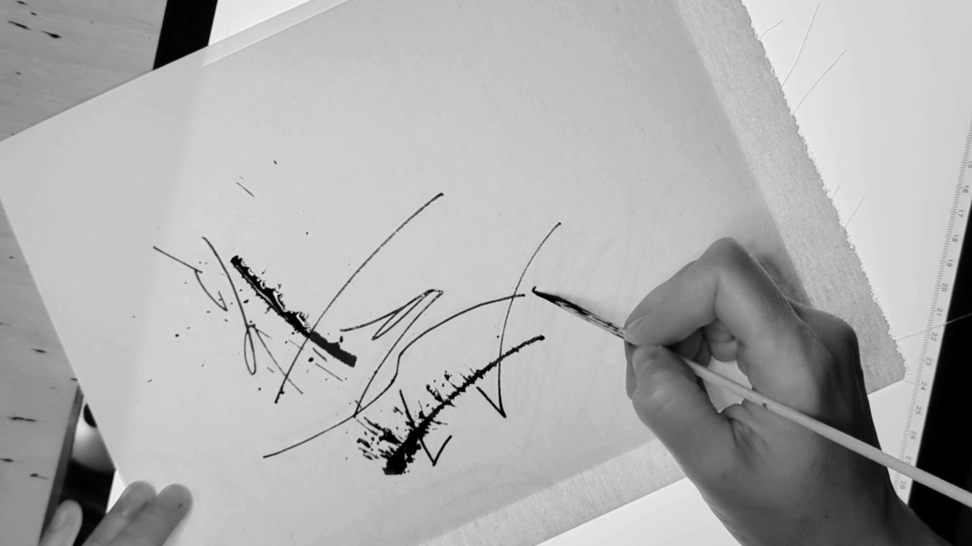 Mary Pavlova is writing a calligraphy piece called Cat-astrophe