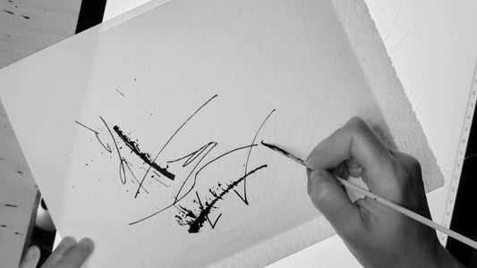 Mary Pavlova is writing a calligraphy piece called Cat-astrophe