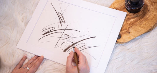 Monochrome Calligraphy artwork called For Love in hands, holding it