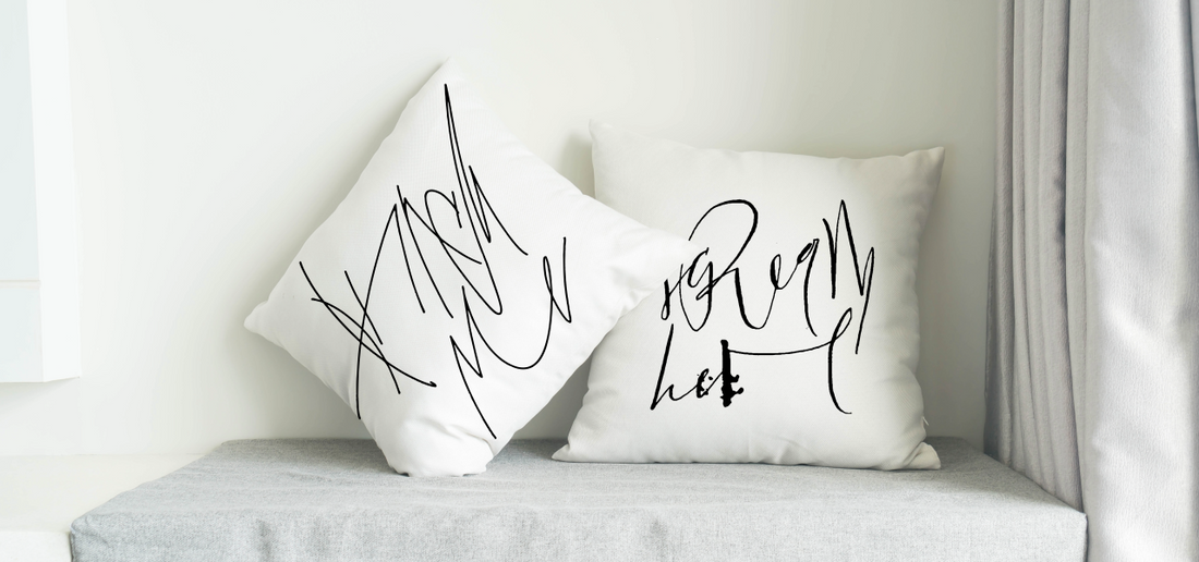 White Pillows with the calligraphy art that says: "Punch me" and "Scream here"