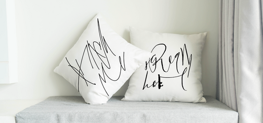 White Pillows with the calligraphy art that says: "Punch me" and "Scream here"