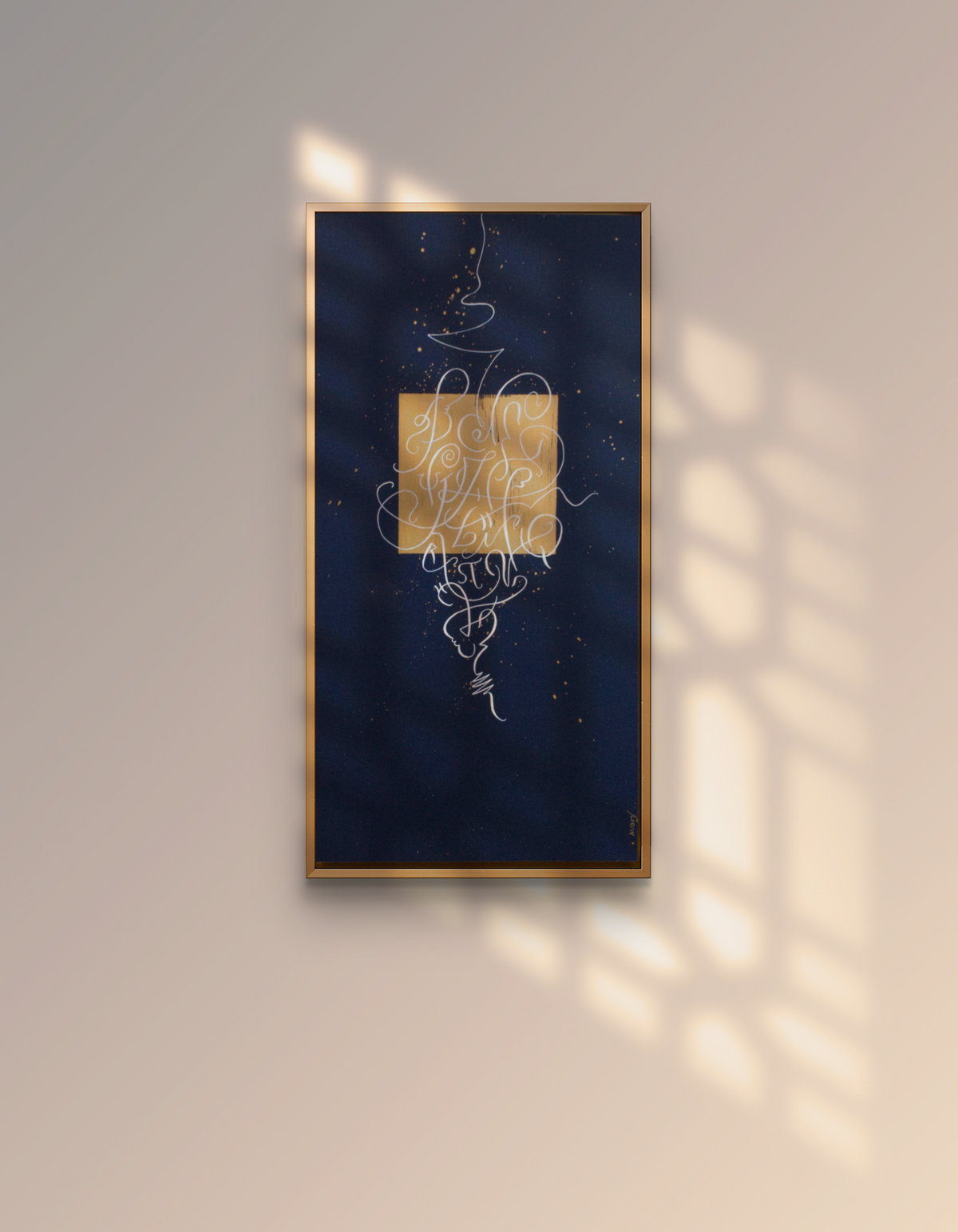 Alphabet original abstract calligraphy artwork in dark blue and gold by Mary Pavlova on the wall in a warm light