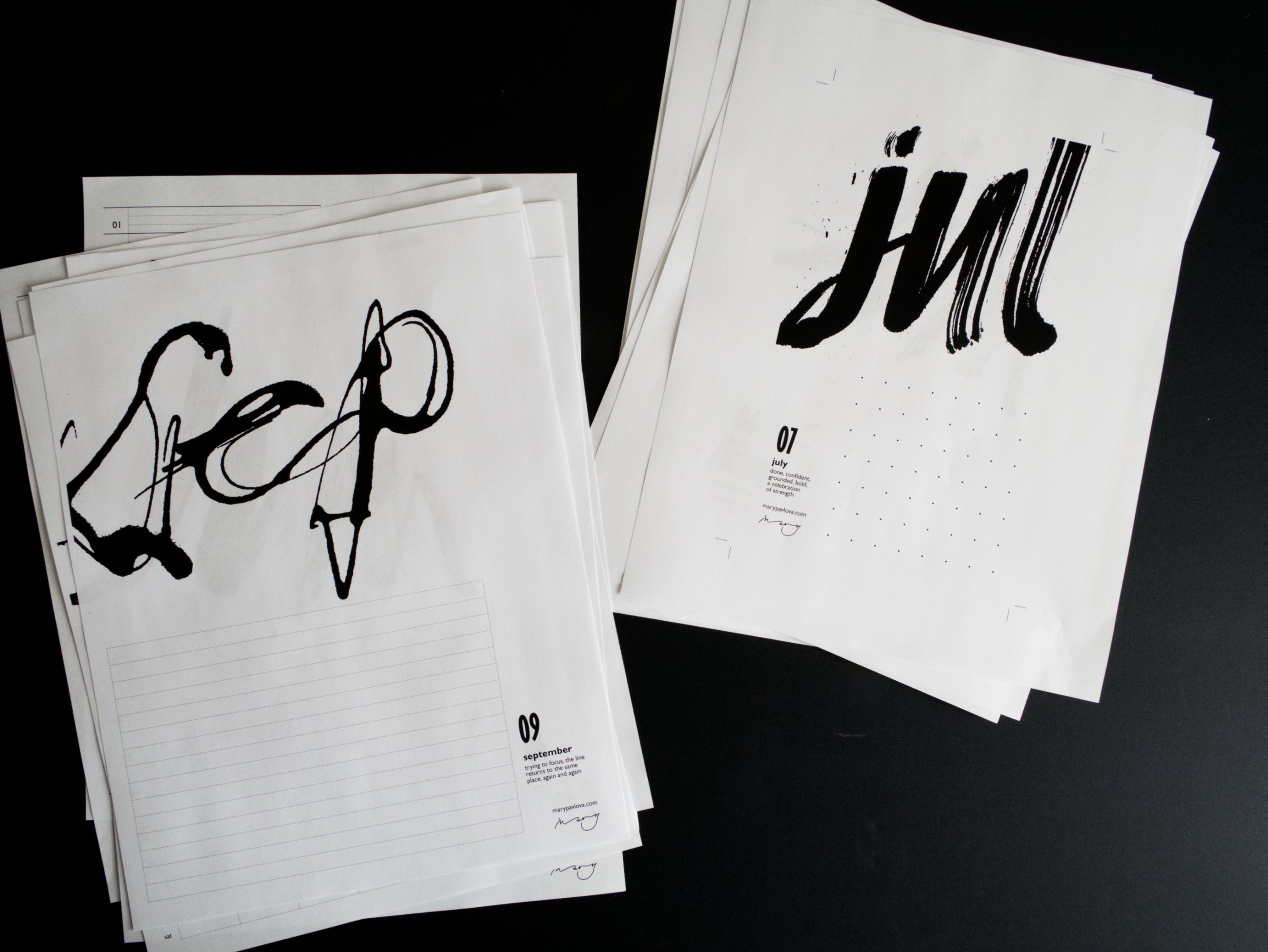 Twenty sheets of paper with black calligraphy on a dark background