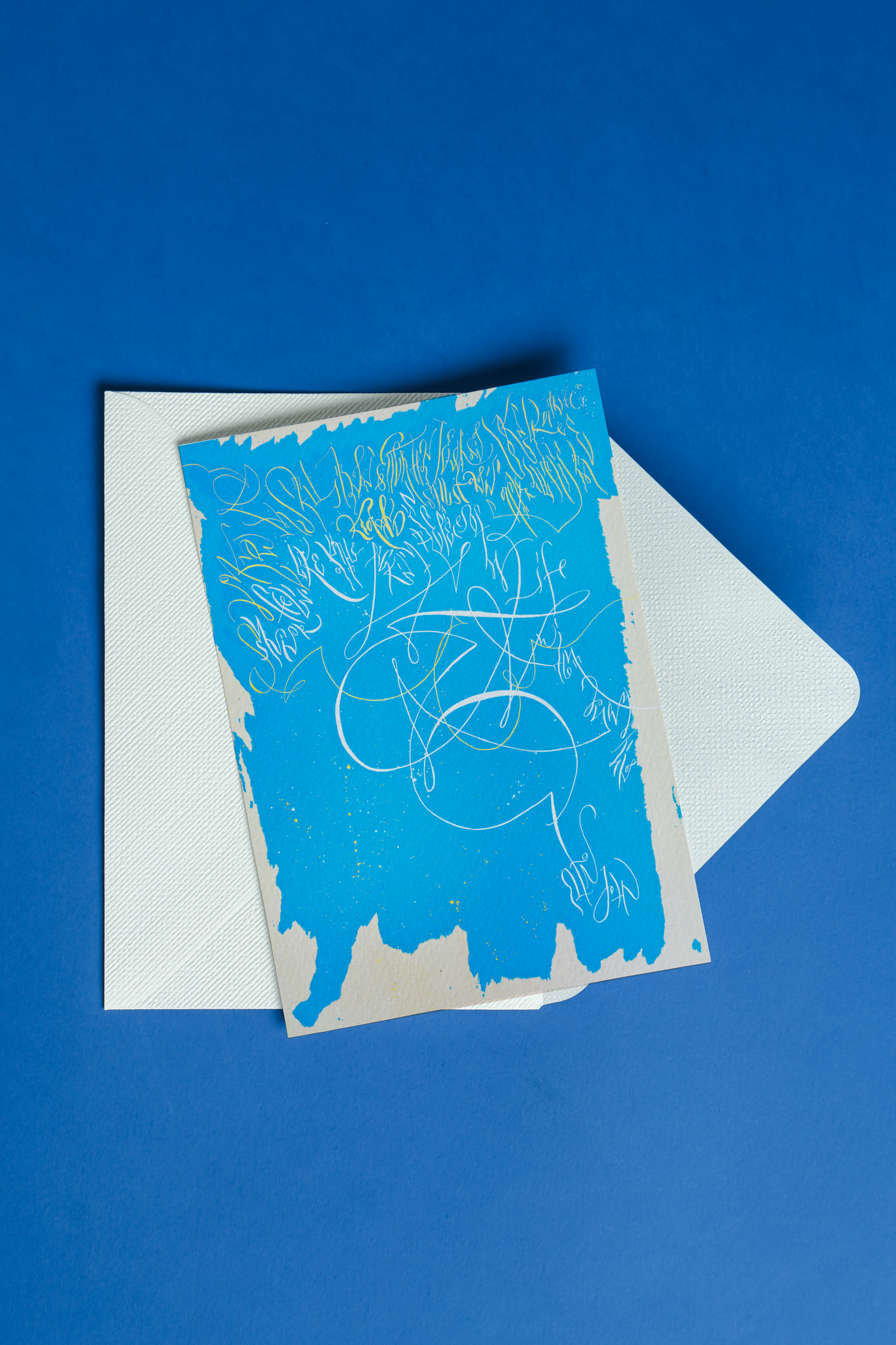 Blue greeting card with Still standing artwork on a white envelope against a blue background