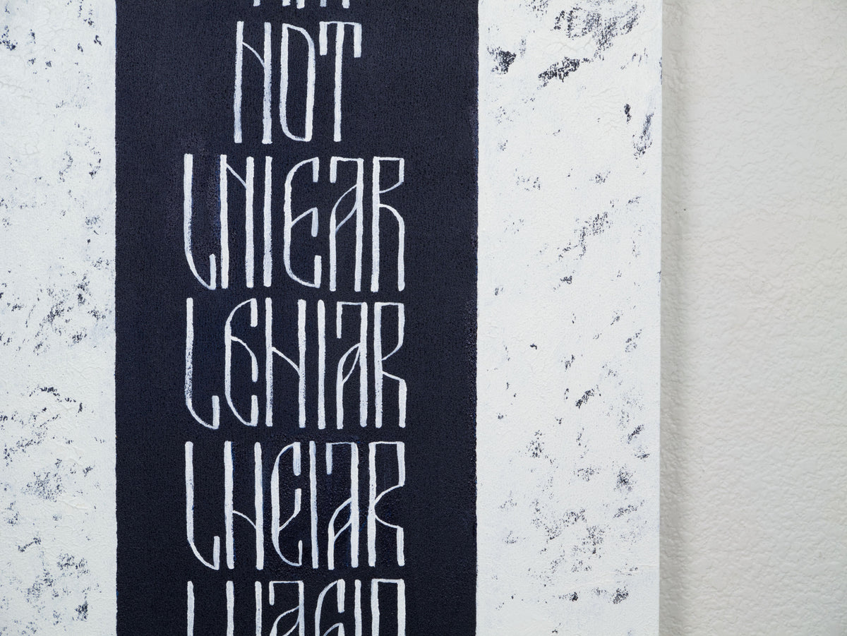 Detail of I Am Not Linear original text-based artwork  in dark blue and white  by Mary Pavlova