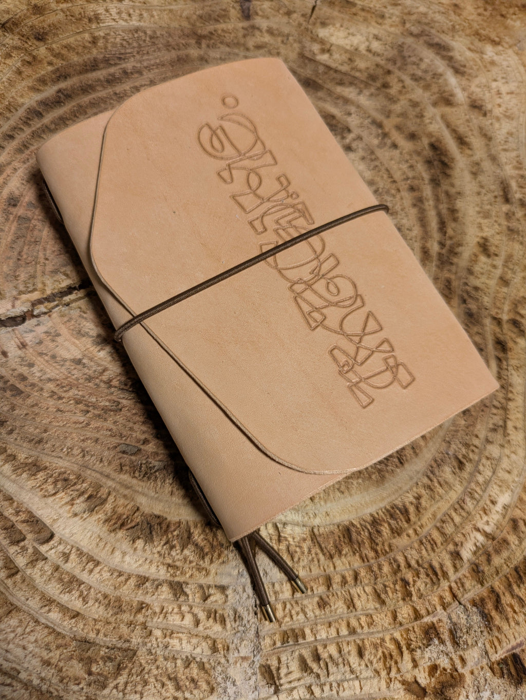 Leather notebook with embossed text on a textured surface