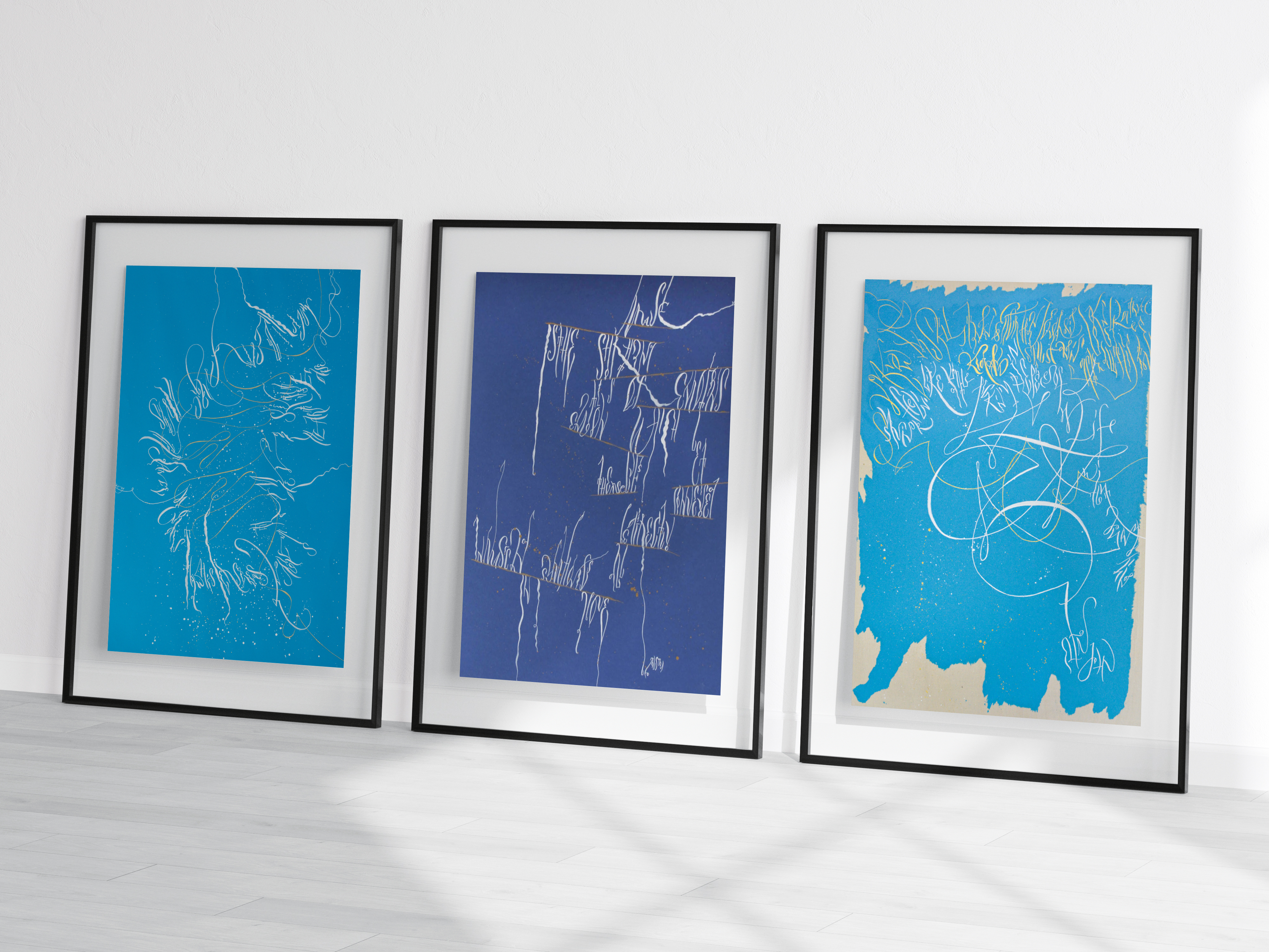 Three framed abstract artworks on a white surface with a light gray background