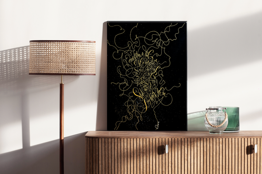 Golden calligraphy art on black canvas is standing on the wood drawer
